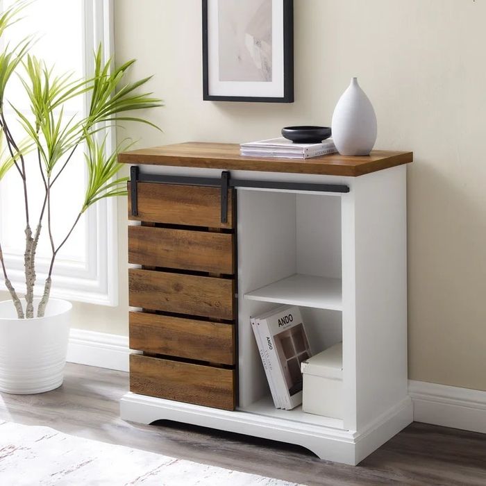 A white/reclaimed barnwood server, neatly holding personal items while enhancing the room's aesthetic.