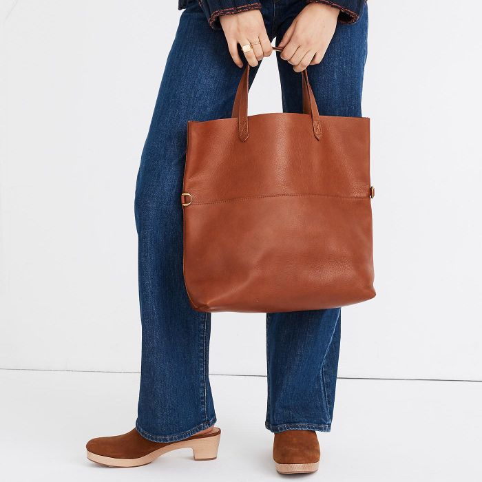 model sporting a cognac-colored purse