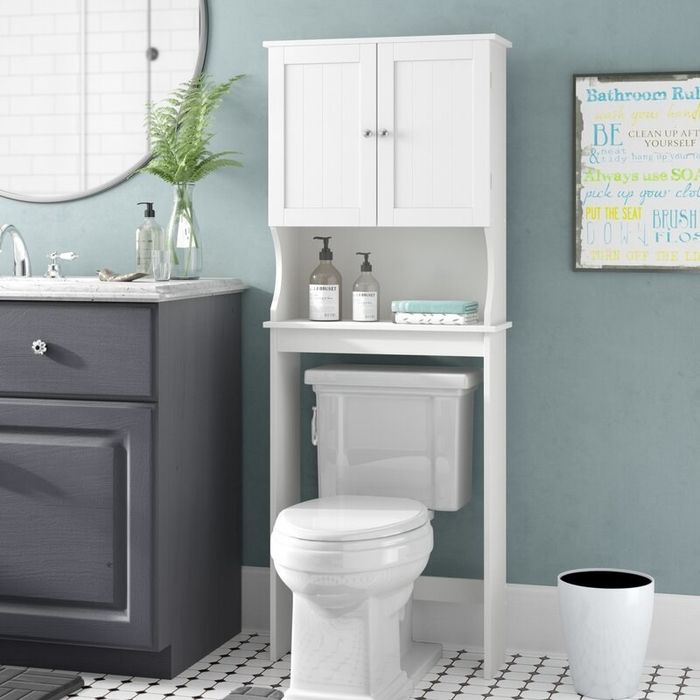 The white semi-gloss cabinet installed above a toilet.