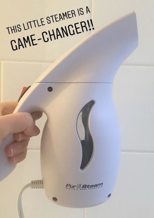 Mytour Shopping reviewer holding the mini steamer, with the caption: 