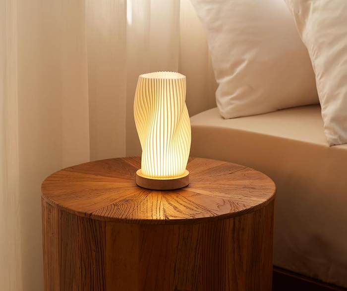 A lamp sitting on a bedside table