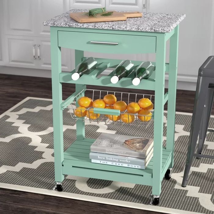 A green cart holding kitchen essentials, combining functionality and style effortlessly.