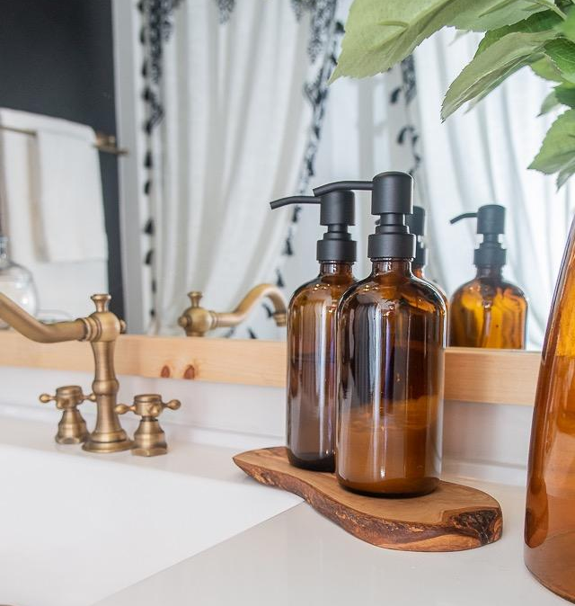 The soap dispensers with black pumps resting on a bathroom counter.