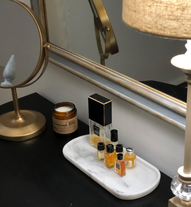 Another reviewer’s collection of perfume bottles displayed on a pristine white marble tray