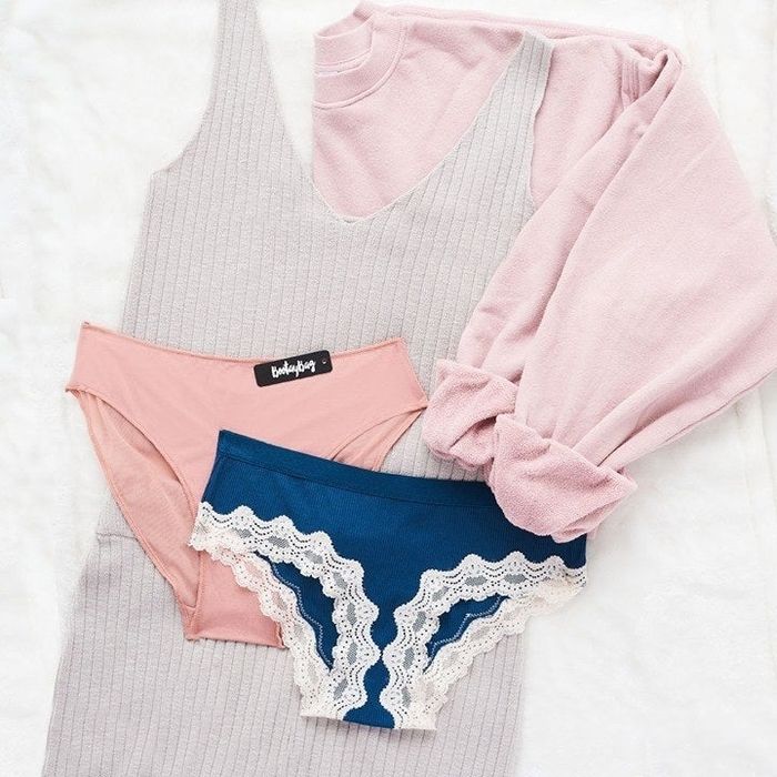 two pairs of underwear, one pink and the other blue with lace trim