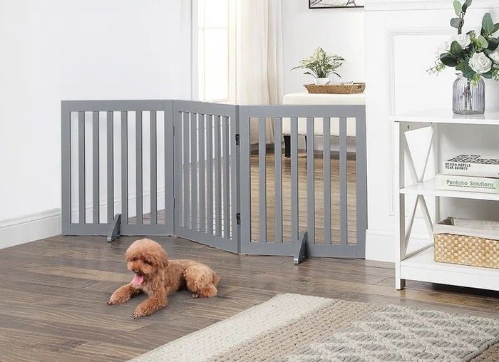 The gate in gray, placed to block a hallway and complement the home’s interior.