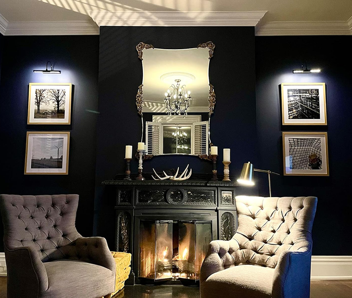The lights glowing above two portraits