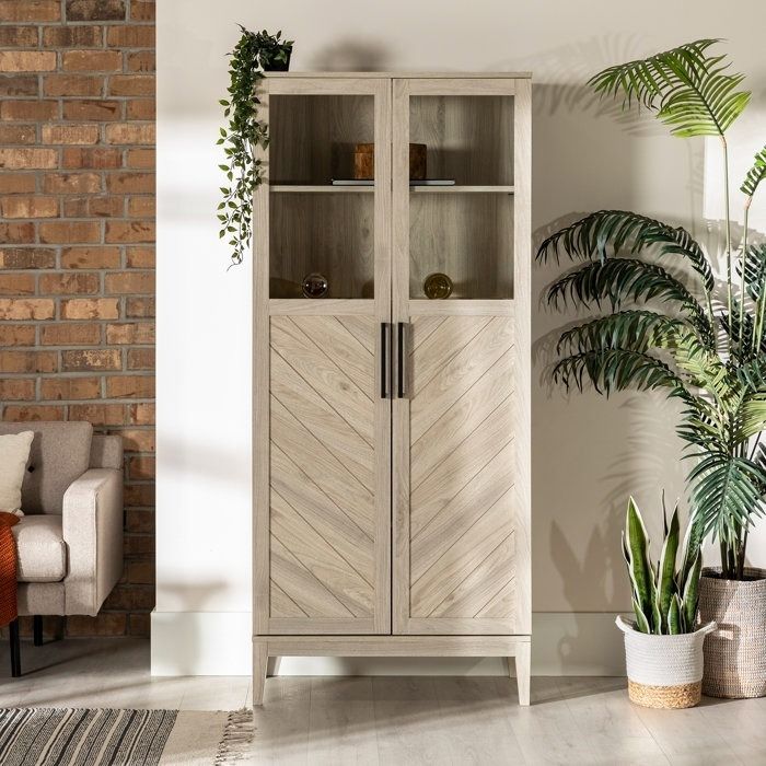 A tall wooden china cabinet with glass panel doors, styled elegantly in a living room setting, blending functionality with aesthetic appeal.