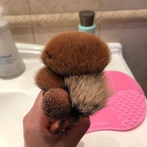 Mytour Editor Heather holding brushes that are visibly dirty