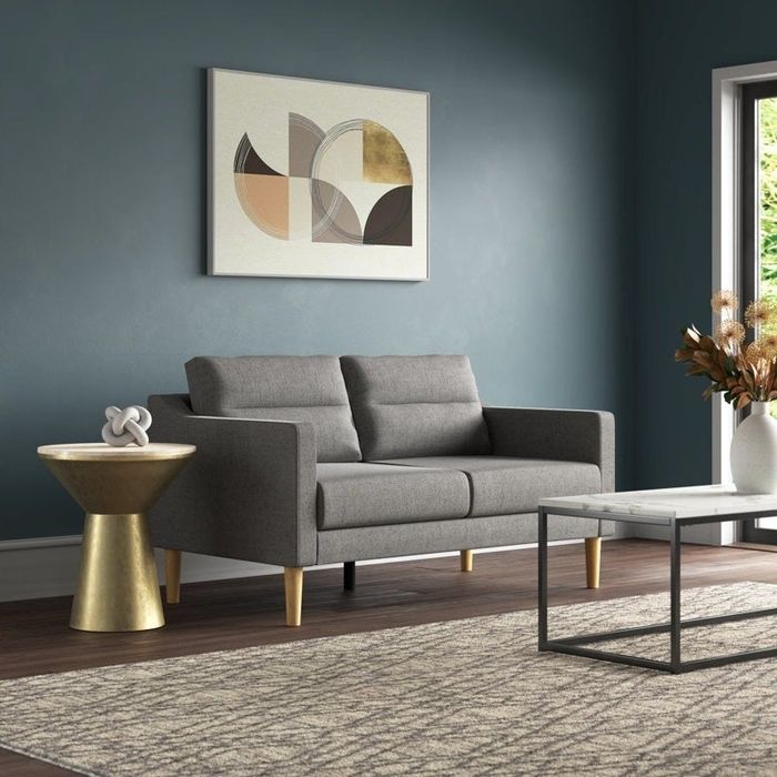 Gray MCM-inspired tufted loveseat in the living room