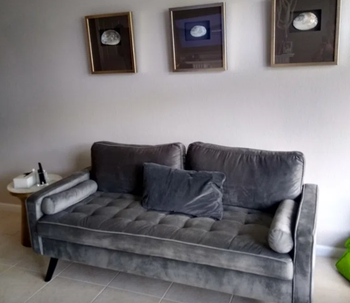 reviewer image of the gray sofa in a well-designed living room