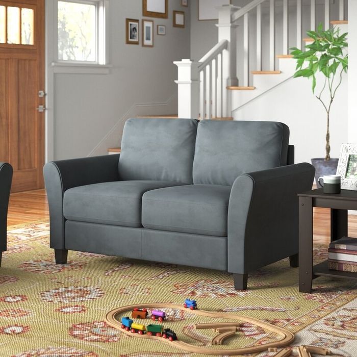 The flared-arm loveseat in a rich dark gray shade
