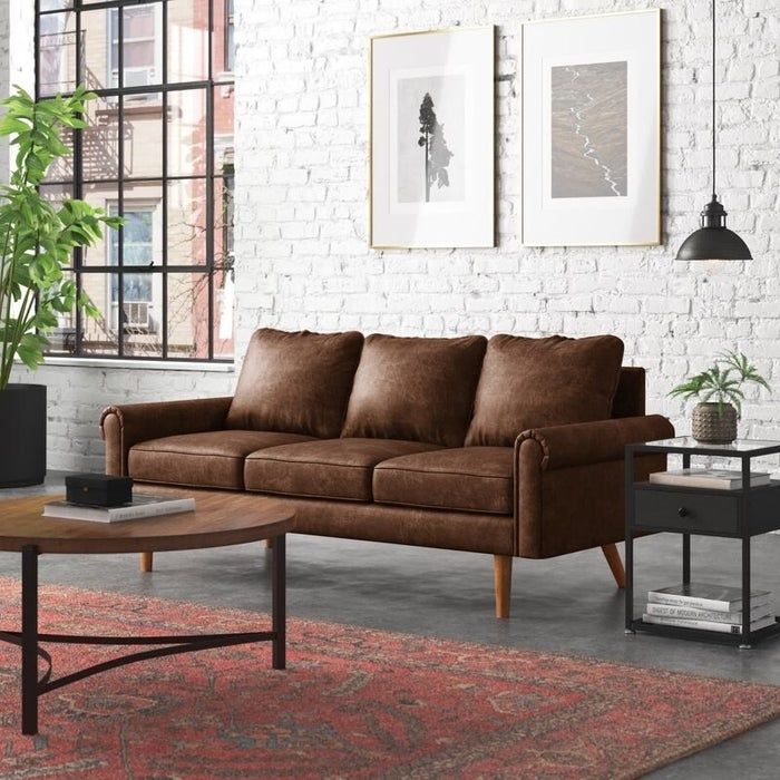 The dark brown rolled-arm sofa
