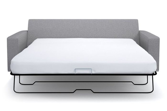 A gray couch with a built-in mattress, offering both comfort and function.
