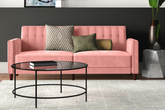 A soft pink couch that adds a cheerful touch to any room.