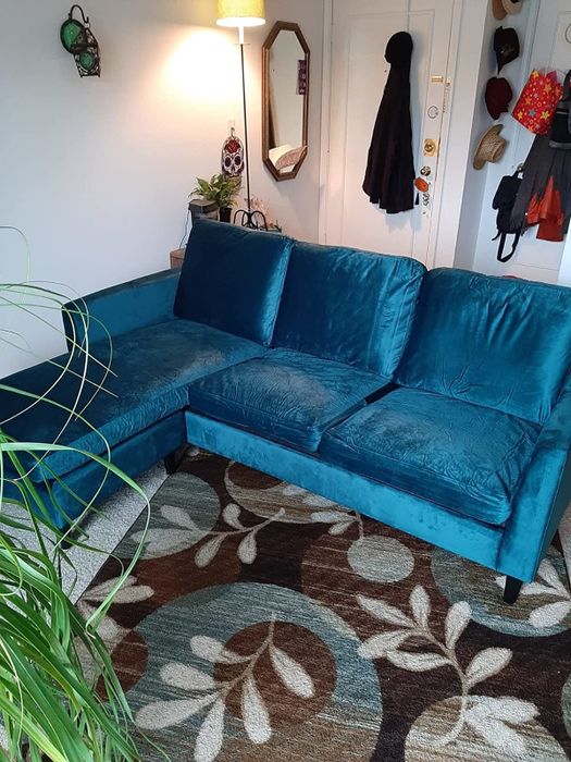 A photo from an Amazon reviewer showcasing the green/blue velvet sectional sofa.