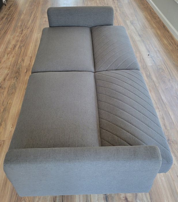 The same reviewer's photo of the sofa transformed into a futon bed.