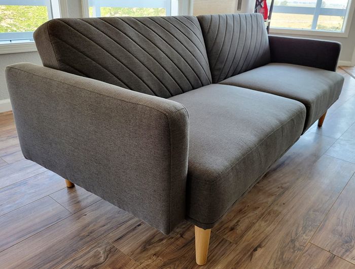 A reviewer's photo showcasing the gray sofa.