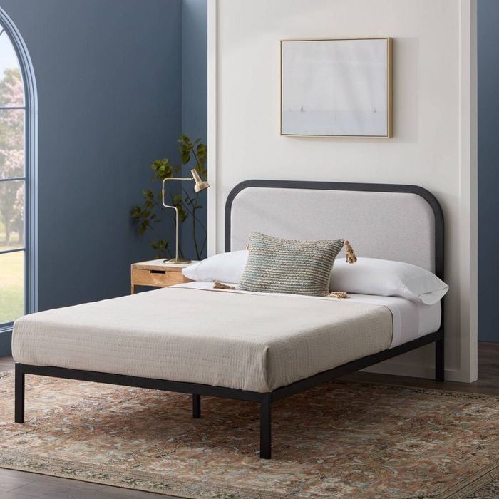 Lifestyle photo of a platform bed with a rounded headboard