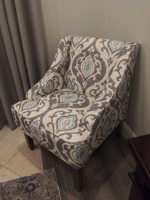 A photo from a reviewer featuring their accent chair in gray, white, and blue patterns, adding a stylish touch to their space.