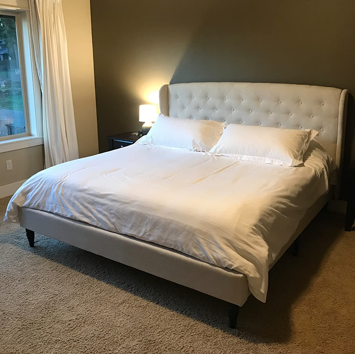 Another reviewer’s snapshot of the tufted beige linen bed frame in a tranquil bedroom, showcasing its elegant design.