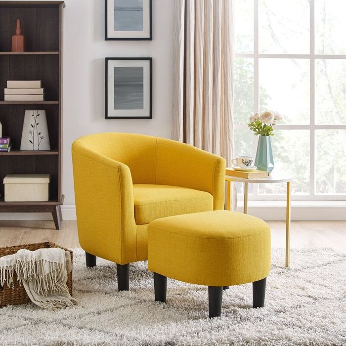 A vibrant yellow chair paired with a matching ottoman.