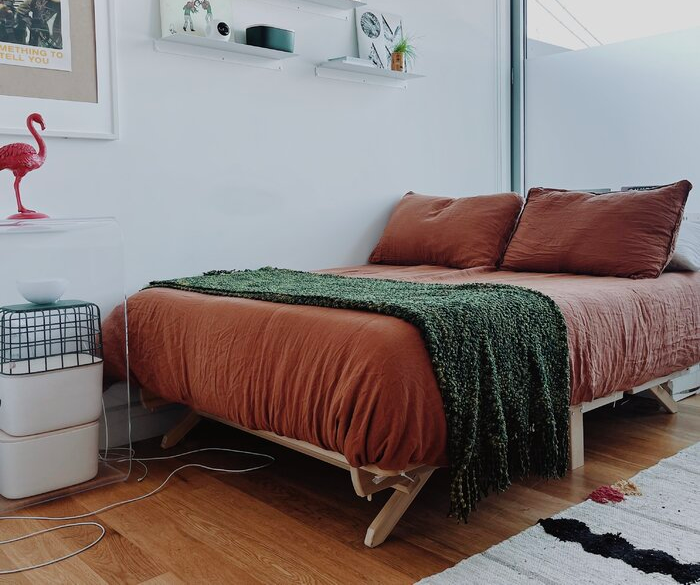 Reviewer's photo of a wooden low-profile platform bed