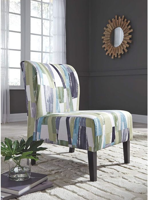 An armless chair with an abstract print featuring green, white, and blue stripes.