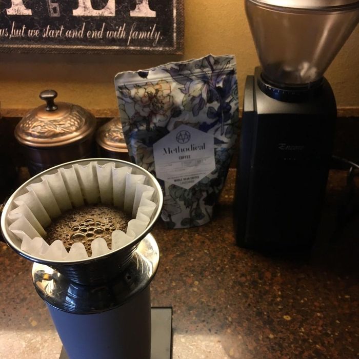 Reviewer brewing coffee with freshly ground beans from their grinder