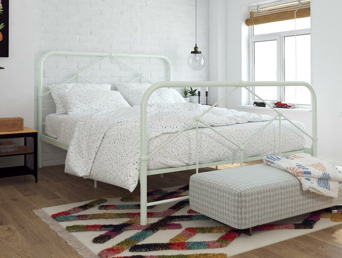 Lifestyle photo of a mint green farmhouse-style bed frame in a bedroom
