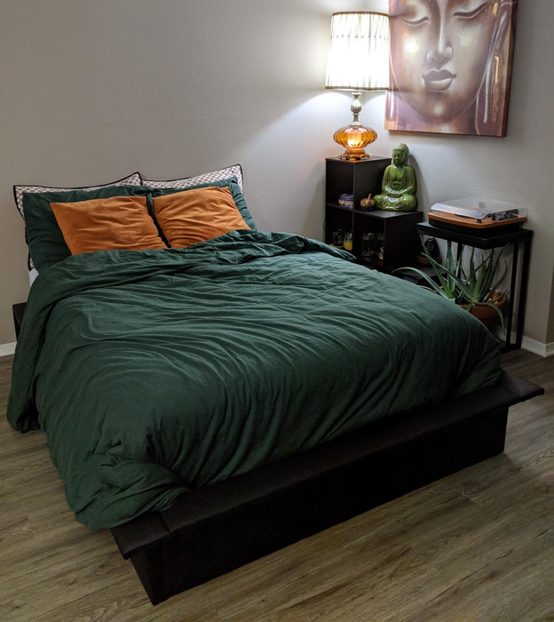 A reviewer’s image of the sleek black platform bed in a stylish bedroom setting, demonstrating its versatility and modern appeal.