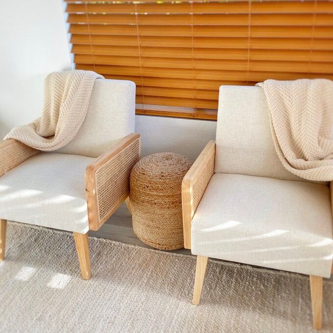 A reviewer photo showing their two white linen upholstered wooden armchairs