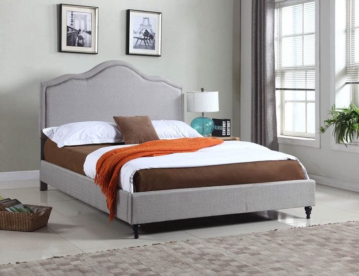 A lifestyle shot showcasing a stylish gray upholstered bed frame.