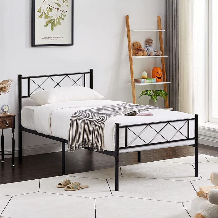Lifestyle photo of a black metal frame bed in a modern bedroom