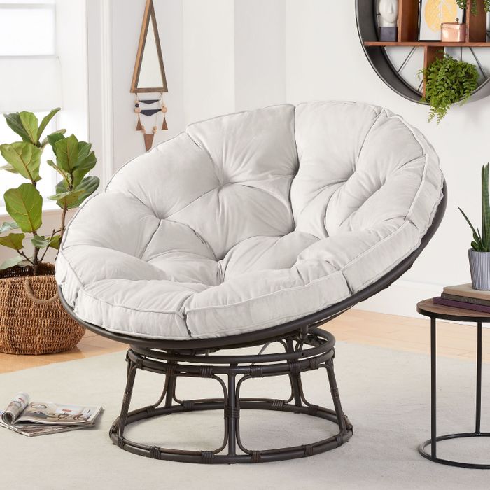 A sleek black papasan chair featuring a soft light grey cushion in a circular shape, perfect for any contemporary setting.