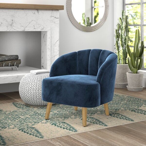 An elegant velvet blue accent chair that adds a pop of color and style to any room. A simple yet striking design that catches the eye.