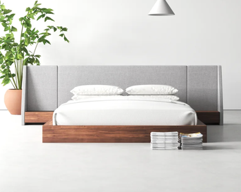 A lifestyle image showing a bed with a hybrid fabric headboard, complemented by nightstands on each side.