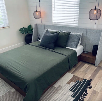 A reviewer’s photo of the nightstand bed in a cozy bedroom setting.