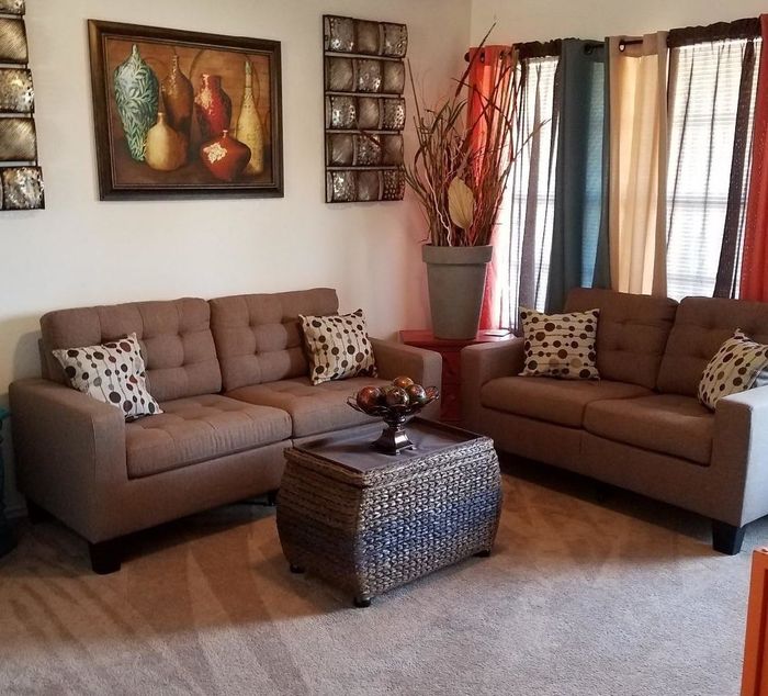 Reviewer photo showcasing a cozy brown fabric couch with playful polka-dot throw pillows