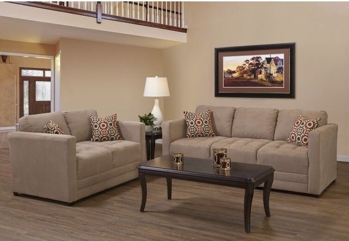 Two rich brown couches placed around a dark brown coffee table
