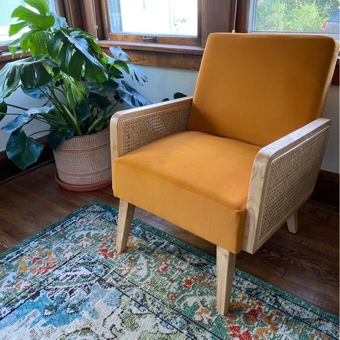A reviewer photo of their yellow upholstered wooden armchair