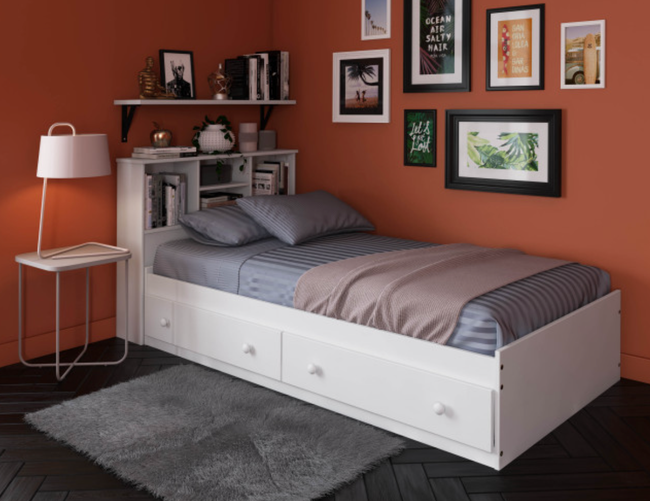A stylish lifestyle photo of a white twin storage bed perfectly placed in a cozy bedroom.