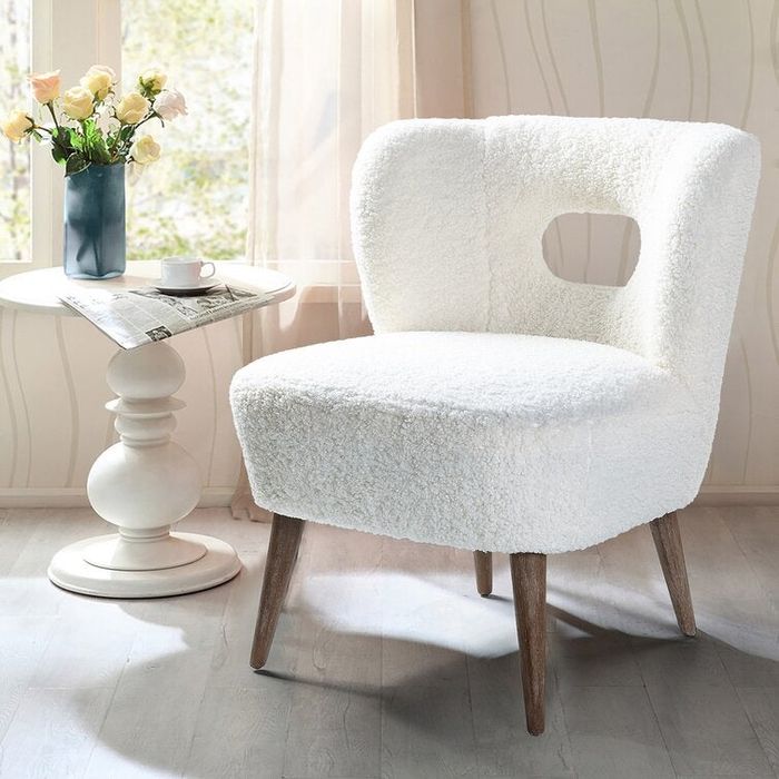 A soft white cutout chair with plush cushioning for a comfortable and stylish seating option.
