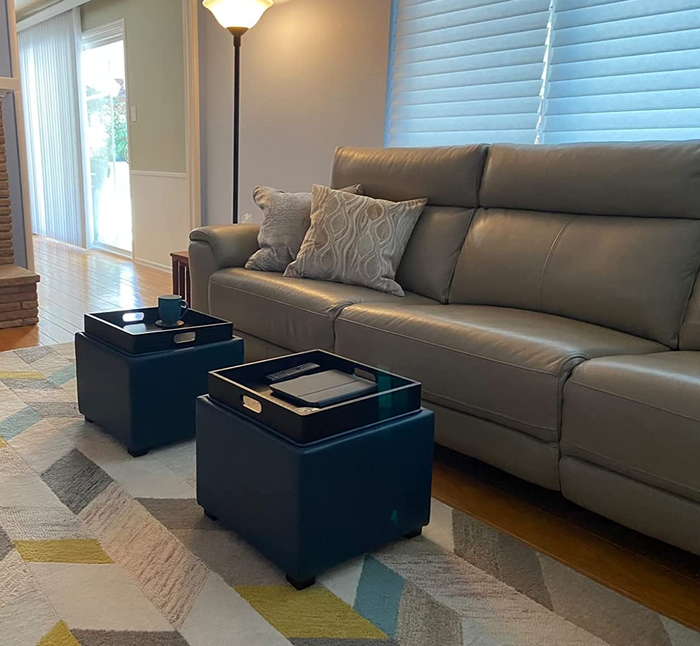 reviewer photo of two black ottoman cubes with storage trays on top