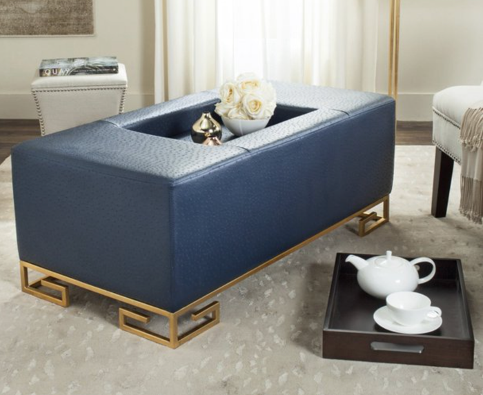 A blue rectangular ottoman with a leather-like appearance and a tray insert.
