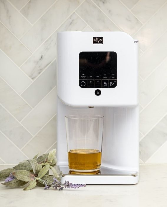 A white oil infuser resting on the countertop