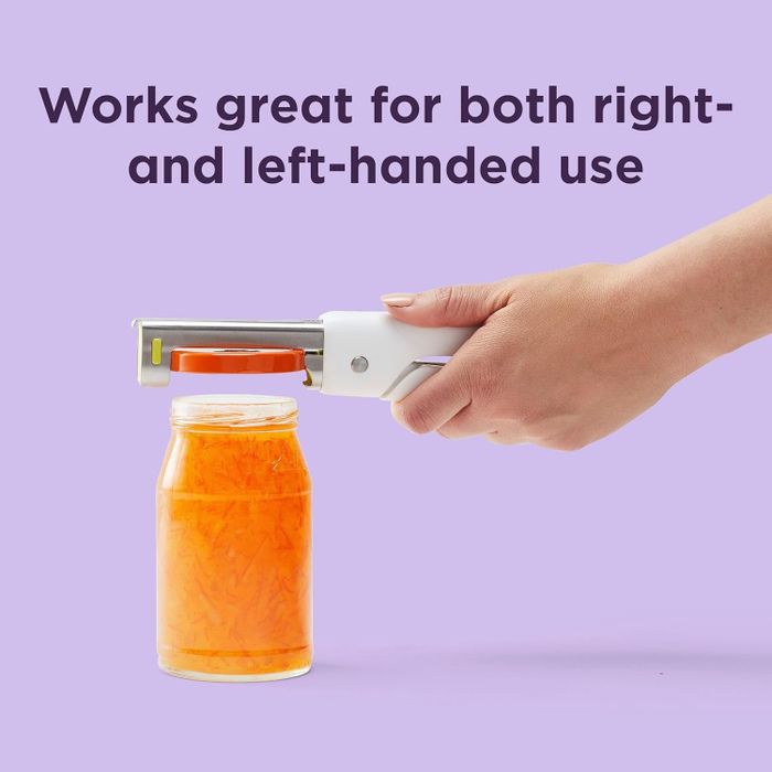 A hand using a jar opener on a jar of shredded carrots, with text stating it works for both right- and left-handed users.