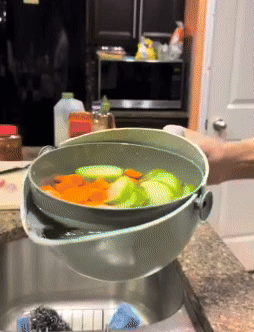 A reviewer using the colander to strain vegetables