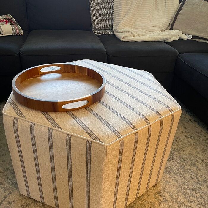A photo from a reviewer showcasing the ottoman with a decorative tray placed atop it.