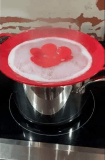 A gif of a reviewer demonstrating how the spill stopper keeps the water from overflowing.